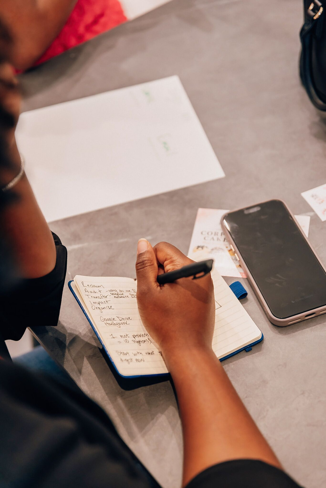 An attendee taking notes and building her operational blueprint