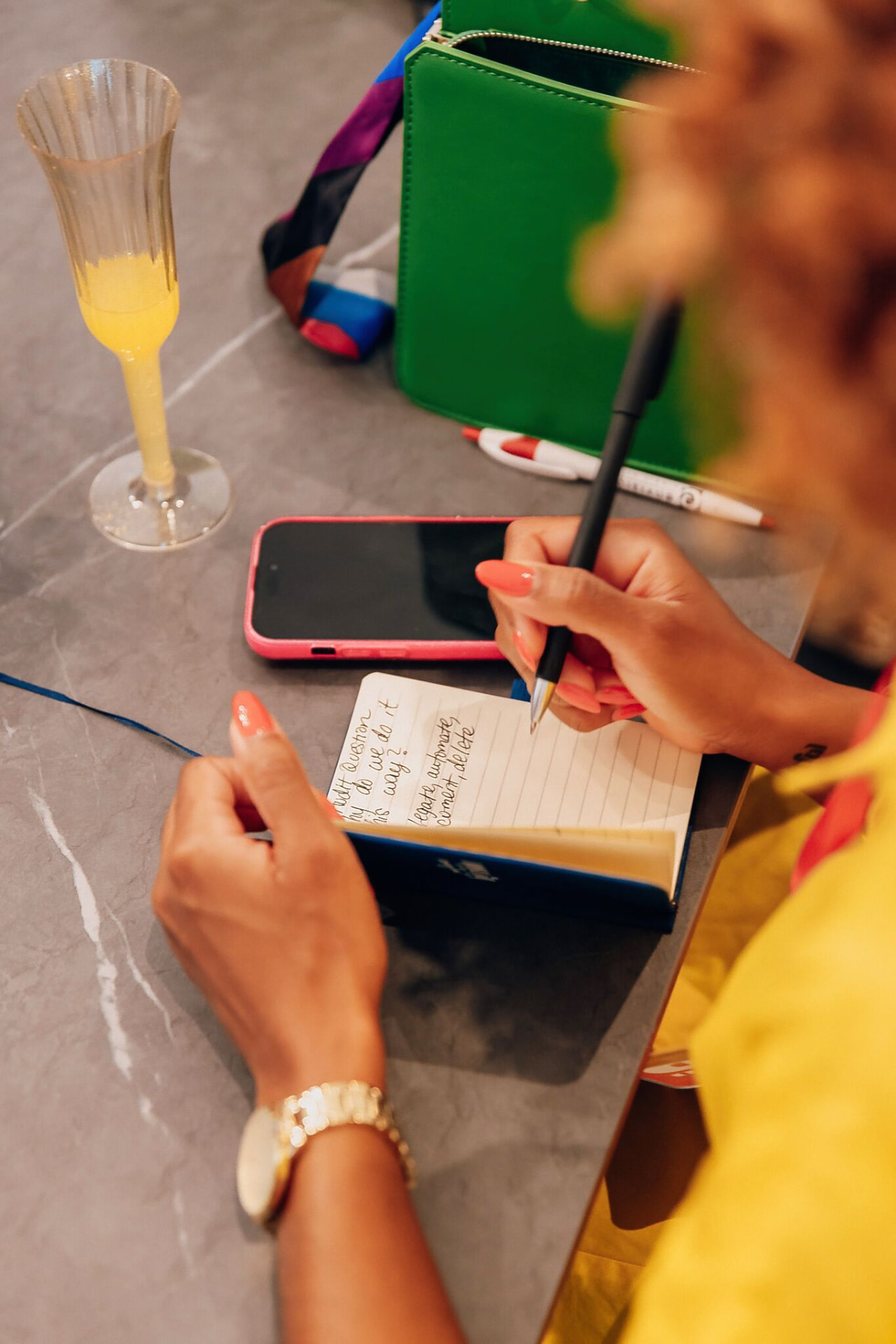 An attendee capturing notes and next steps in her planner